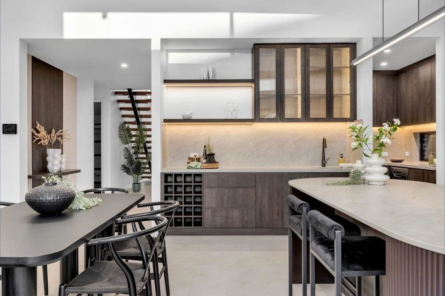 Modern kitchen styled by RitZi Stagings with dark timber cabinetry.